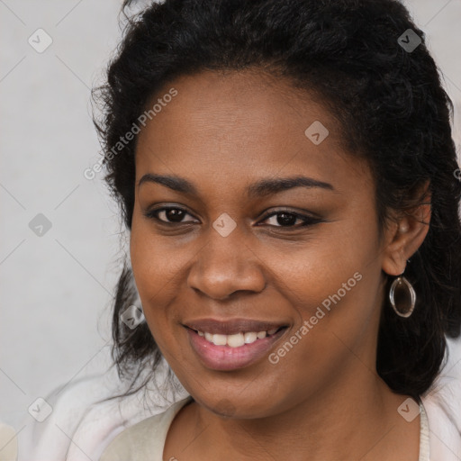 Joyful black young-adult female with long  brown hair and brown eyes