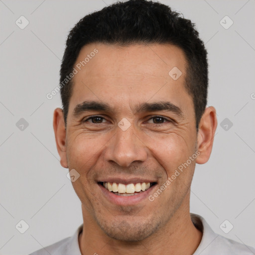 Joyful white adult male with short  black hair and brown eyes