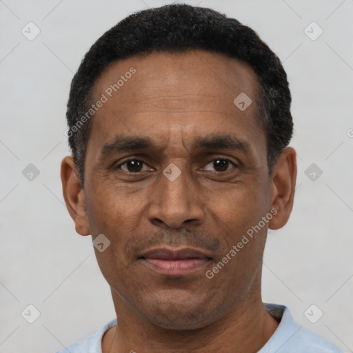 Joyful latino adult male with short  black hair and brown eyes