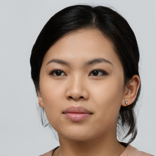 Joyful asian young-adult female with medium  black hair and brown eyes