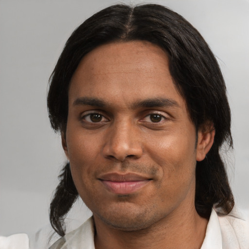 Joyful white adult male with medium  black hair and brown eyes