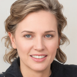 Joyful white young-adult female with medium  brown hair and blue eyes