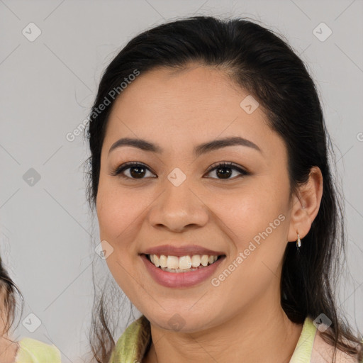 Joyful latino young-adult female with medium  brown hair and brown eyes