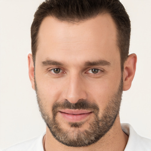 Joyful white young-adult male with short  brown hair and brown eyes