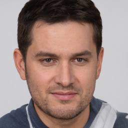 Joyful white young-adult male with short  brown hair and brown eyes