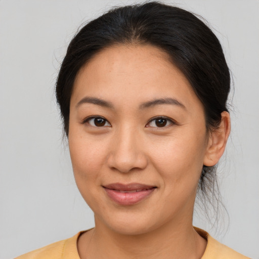 Joyful latino young-adult female with medium  brown hair and brown eyes