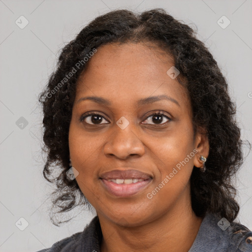 Joyful black young-adult female with long  brown hair and brown eyes