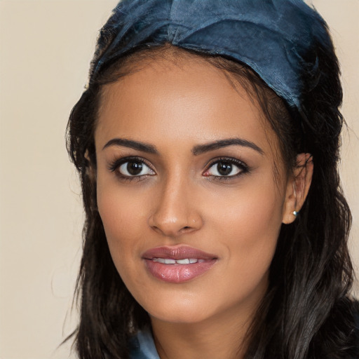 Joyful white young-adult female with long  black hair and brown eyes