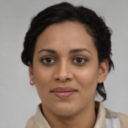 Joyful latino young-adult female with short  brown hair and brown eyes