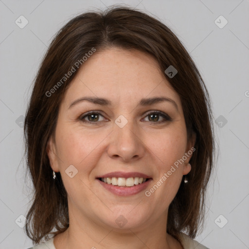 Joyful white adult female with medium  brown hair and grey eyes