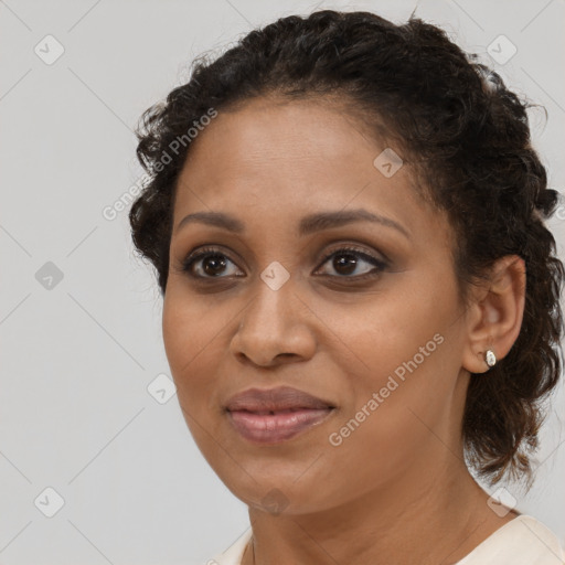 Joyful black young-adult female with medium  brown hair and brown eyes