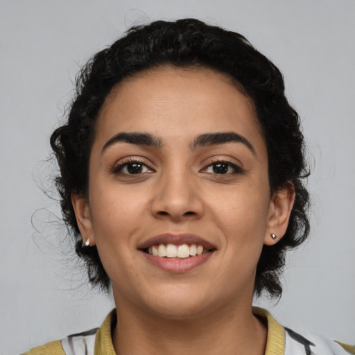 Joyful latino young-adult female with medium  black hair and brown eyes
