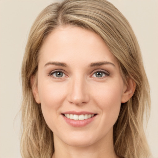 Joyful white young-adult female with long  brown hair and green eyes