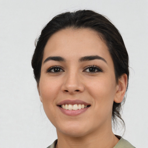Joyful latino young-adult female with medium  black hair and brown eyes