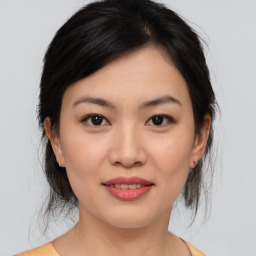 Joyful asian young-adult female with medium  brown hair and brown eyes