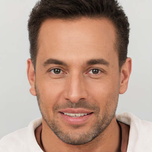 Joyful white young-adult male with short  brown hair and brown eyes