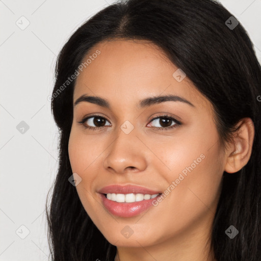 Joyful latino young-adult female with long  brown hair and brown eyes