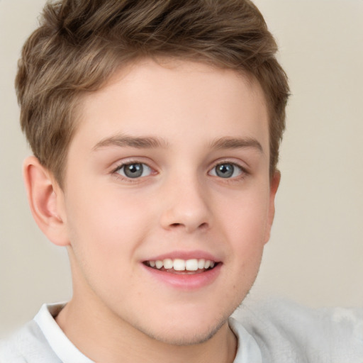 Joyful white child male with short  brown hair and grey eyes