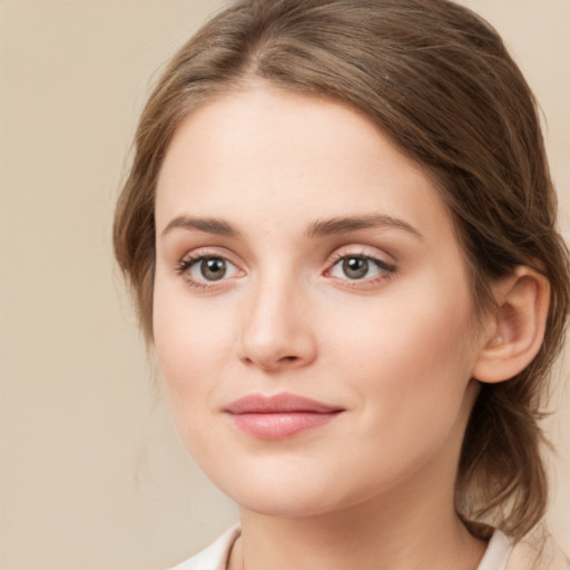 Joyful white young-adult female with medium  brown hair and green eyes