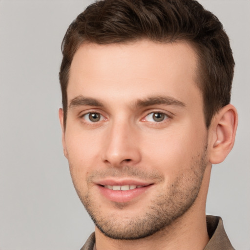 Joyful white young-adult male with short  brown hair and brown eyes