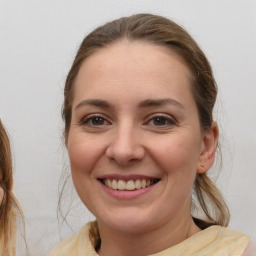 Joyful white young-adult female with medium  brown hair and brown eyes