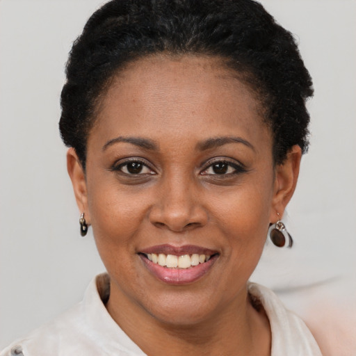 Joyful latino young-adult female with short  black hair and brown eyes