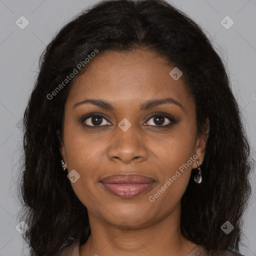Joyful black young-adult female with long  brown hair and brown eyes