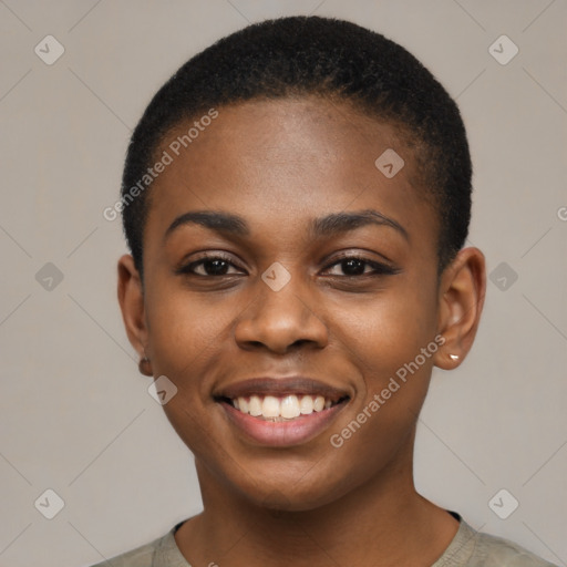 Joyful black young-adult female with short  black hair and brown eyes