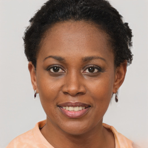 Joyful black young-adult female with short  brown hair and brown eyes