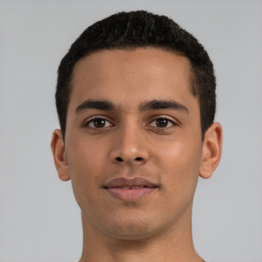 Joyful latino young-adult male with short  brown hair and brown eyes