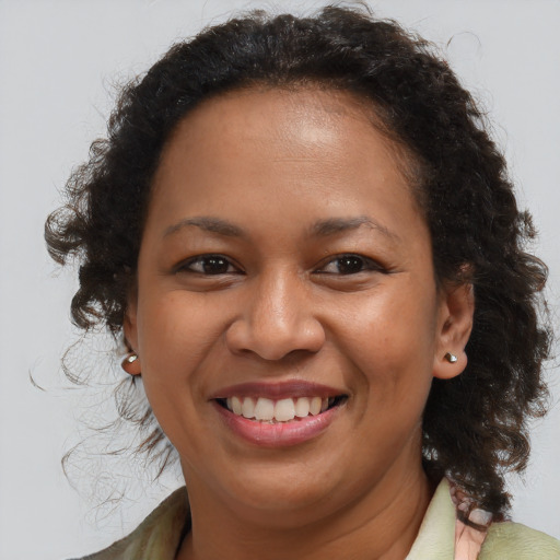 Joyful black young-adult female with medium  brown hair and brown eyes
