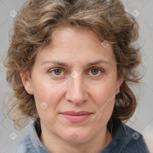 Joyful white adult female with medium  brown hair and blue eyes