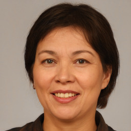 Joyful white adult female with medium  brown hair and brown eyes