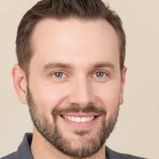 Joyful white young-adult male with short  brown hair and brown eyes