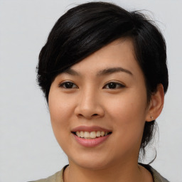 Joyful asian young-adult female with medium  black hair and brown eyes