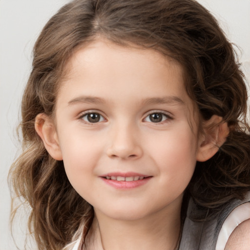 Joyful white child female with medium  brown hair and brown eyes