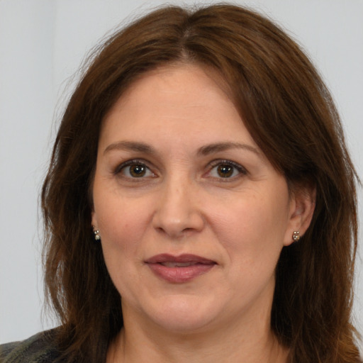 Joyful white adult female with medium  brown hair and brown eyes