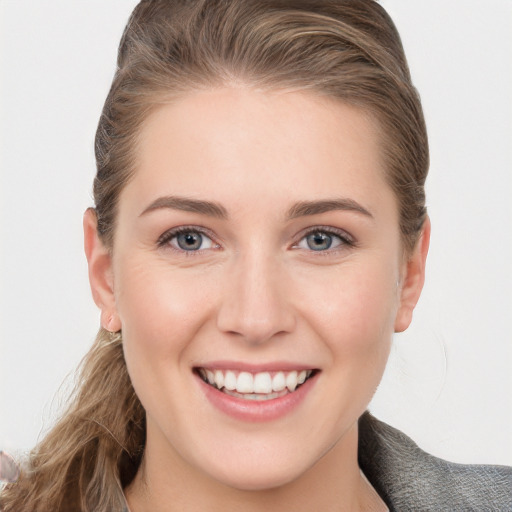 Joyful white young-adult female with long  brown hair and grey eyes