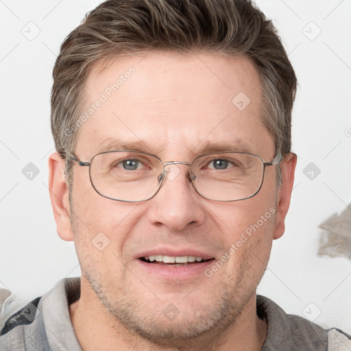 Joyful white adult male with short  brown hair and grey eyes