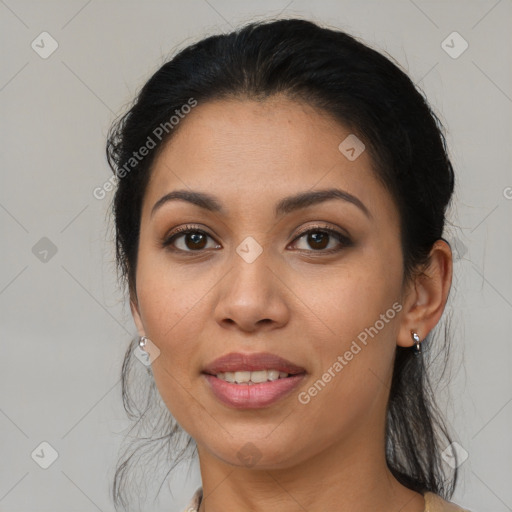 Joyful latino young-adult female with medium  brown hair and brown eyes