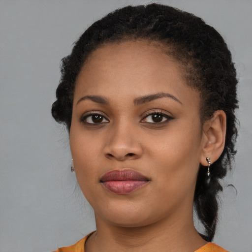 Joyful black young-adult female with medium  brown hair and brown eyes