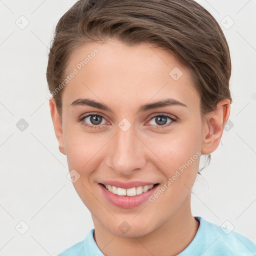 Joyful white young-adult female with short  brown hair and grey eyes