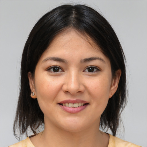 Joyful asian young-adult female with medium  brown hair and brown eyes