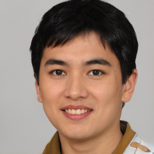 Joyful asian young-adult male with short  brown hair and brown eyes