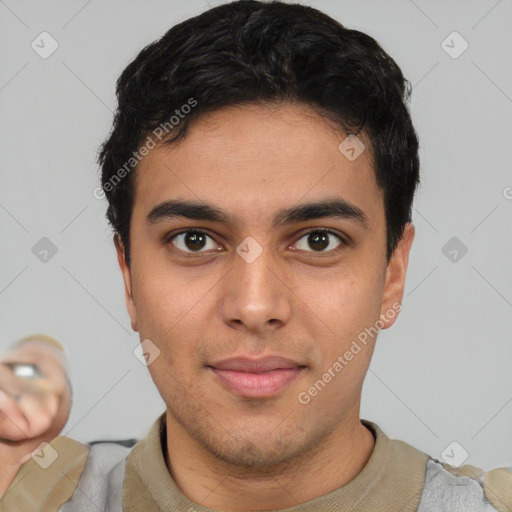 Joyful latino young-adult male with short  black hair and brown eyes