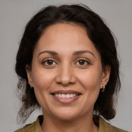 Joyful white adult female with medium  brown hair and brown eyes