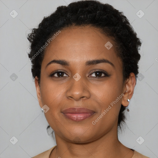 Joyful black young-adult female with short  black hair and brown eyes