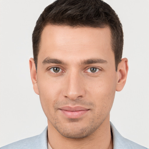 Joyful white young-adult male with short  brown hair and brown eyes