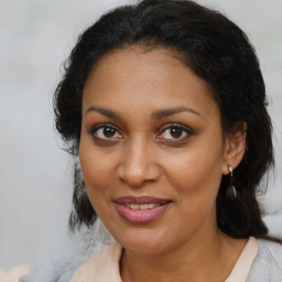 Joyful black young-adult female with medium  brown hair and brown eyes