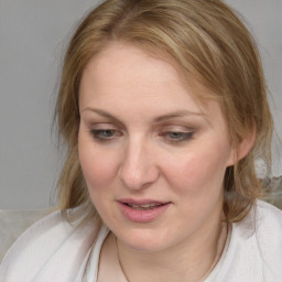 Joyful white young-adult female with medium  brown hair and blue eyes